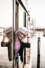 Businesswoman Wearing Sailor Hat, Working On A Houseboat