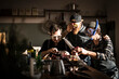 © MalteJaeger / Westend61/Westend61 - Friends chopping onions with swimming goggles