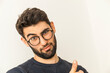 © Thomas Degen/Westend61 - Portrait of doubting young man with beard and glasses