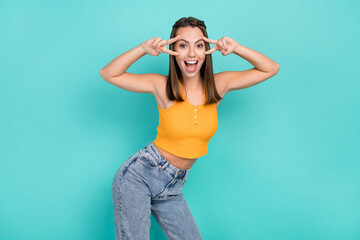 Sticker - Photo of positive happy joyful young woman hold face two v-signs good mood lady isolated on teal color background