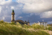 Germany, Mecklenburg-West Pomerania, Warnemunde, Grass On Sand Dunes And Lighthouse