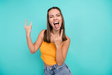 Sticker - Photo of cheerful crazy happy young woman hold rock sign face stick out tongue cool isolated on teal color background