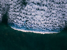 Indonesia, Bali, Seminyak, Aerial View Of Surfers Riding Wave