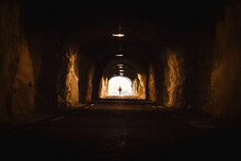 Norway, Lofoten Islands, Maervoll, Silhouette Of Man At The End Of A Tunnel