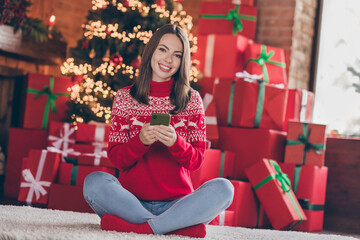 Poster - Photo of cheerful blogger lady sit floor hold telephone device chatting congrats friends in decorated x-mas home indoors