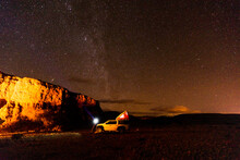 Off-road Car In Illuminated Desert Camp At Night