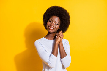 Wall Mural - Photo of charming cheerful dark skin lady folded arms palms toothy smile isolated on yellow color background