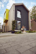 © Maya Claussen/Westend61 - Family sitting on steps outside tiny house
