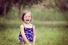 Portrait Of Screaming Little Girl On A Glade
