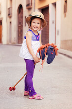 Portrait Of Little Girl With Hobby Horse