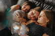 © Mareen Fischinger/Westend61 - Friends sleeping on sofa bed at home