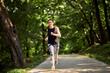 © Dangubic/Westend61 - Sporty young woman running on forest path