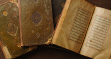 Stack Of Open Ancient Books In Arabic. Old Arabic Manuscripts And Texts. Top View