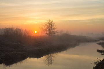 Wall Mural - morning fog over the river red dawn