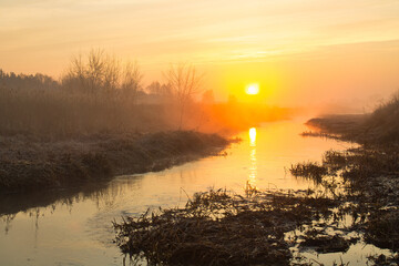 Wall Mural - morning fog over the river red dawn