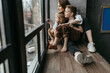 © Oxana Guryanova/Westend61 - Full length of family looking through window at home