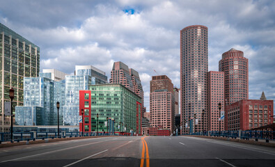 Wall Mural - Boston downtown skyline and dramatic clouds over the Summer Street bridge road in Massachusetts