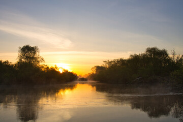 Wall Mural - morning fog over the river red dawn