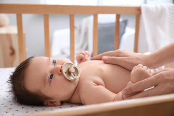 Canvas Print - Cute little baby with pacifier in crib at home