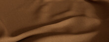 Warm Brown Fabric Background With Wrinkles. Wavy Surface Texture.