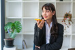 © PaeGAG - cheerful asian businesswoman talking on smartphone in office.