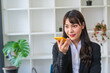 © PaeGAG - cheerful asian businesswoman talking on smartphone in office.