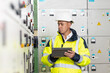 © uflypro - Asian man electrical engineer hold tablet monitoring electrical system in control room. Technician inspect to control panel screen system for generate electricity of factory in manufacture industrial