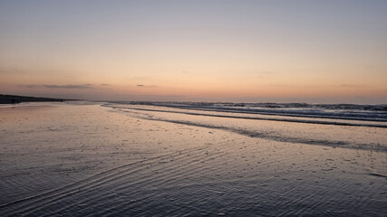 Wall Mural - Big waves on the beach at sunset