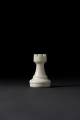 isolated white rook chess piece on black background.