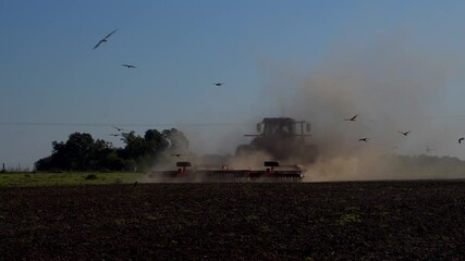 Poster - FIRMAT, ARGENTINA - Sep 21, 2021: A tractor plows the soil in preparation for sowing a field in Firmat, Santa Fe, Argentina