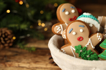 Wall Mural - Delicious homemade Christmas cookies in bowl against blurred festive lights, closeup. Space for text