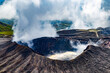 Close up on crater of Aso volcano with clouds and smoke in Kyushu, Japan