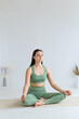 © Вадим Каштанов - Woman practices yoga in the lotus position. Cross-legged pose. Meditation and relaxation.