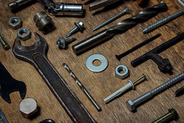 Collection of old tools on a wooden background. The concept of repair and construction work. Old and rusty tools.