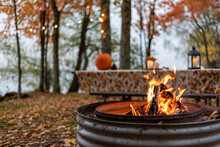 Campfire at a lakeside campground in autumn