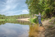 © alexey351 - Fisherman on the bank of a beautiful river.
