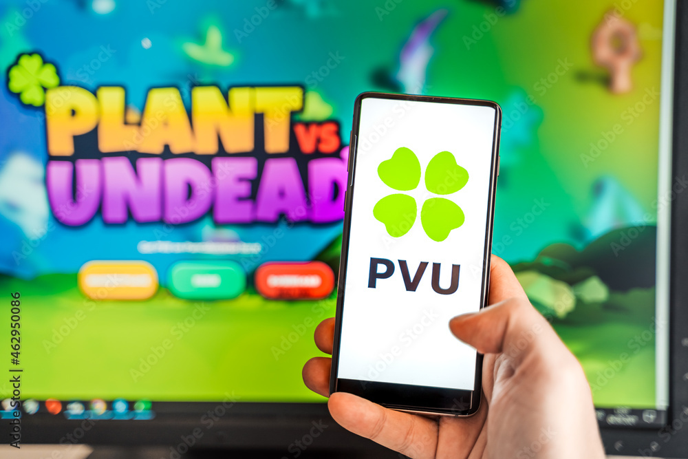 Russia Moscow 04.09.2021.Logo,screenshot of Plant vs Undead, PVU token.Blockchain nft ethereum cryptocurrency game in laptop,mobile phone.Man playing with crypto coins.Earning digital money.Land,hero