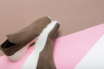 modern beige sneakers with white soles on multicolour background  - Image