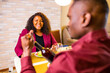 © yurakrasil - african american couple eating italian food pasta in living room in stylish marsala color jacket
