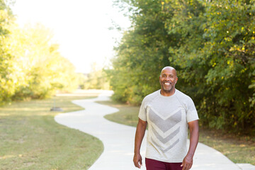 Mature African American man taking a walk outside.