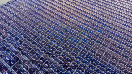 Solar panels on water in aerial view, rows array of polycrystalline silicon solar cells or photovoltaics in Floating Solar Farm on the water in lake.