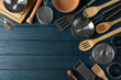 Different kitchen utensil on blue wooden background