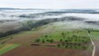 Drohnenaufnahme, Agrarlandschaft  im Spessart mit Wolken und Nebel