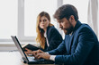 © SHOTPRIME STUDIO - colleagues sitting at a desk with a laptop communication finance officials