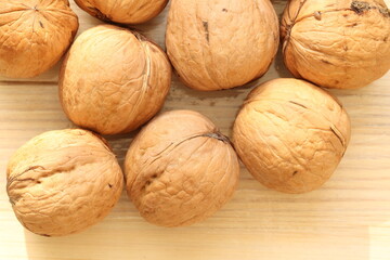 walnut on a light wood background. walnut is the fruit of a tree that can reach a height of 25 meter