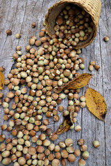 Poster - Beautiful autumn background with leaves and hazelnuts on a wooden surface