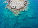 Fototapeta Do pokoju - Azure water texture, transparent sea surface with a rocky bottom. Aerial view, Naxos,natural blue background