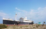 Fototapeta Kwiaty - Le Lydia, a ship grounded on beach at Port-Barcarès, Mediterranean coast, southern France