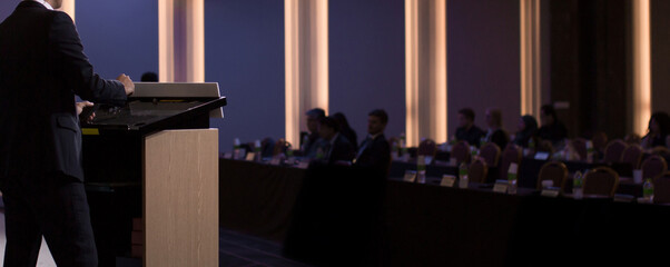Fototapete - Conference photo audience and speaker giving speech. Seminar presenter at CEO forum. Real estate expert in training lecture. Investor pitch presentation workshop picture.
