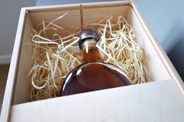 A bottle of whiskey in a wooden gift box.bourbon liquor,present